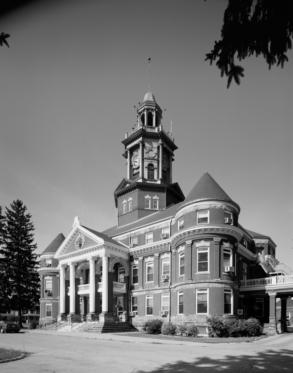 A black and white image of the main building of Polk. According to the Society of Architectural Historians, "The main administration building resembles the courthouse of a rural county seat, combining elements of classicism, as in the Ionic pedimented porch, with such Chateauesque features as the rounded conical-roofed corner towers, steeply sloping roofs, and turrets."
